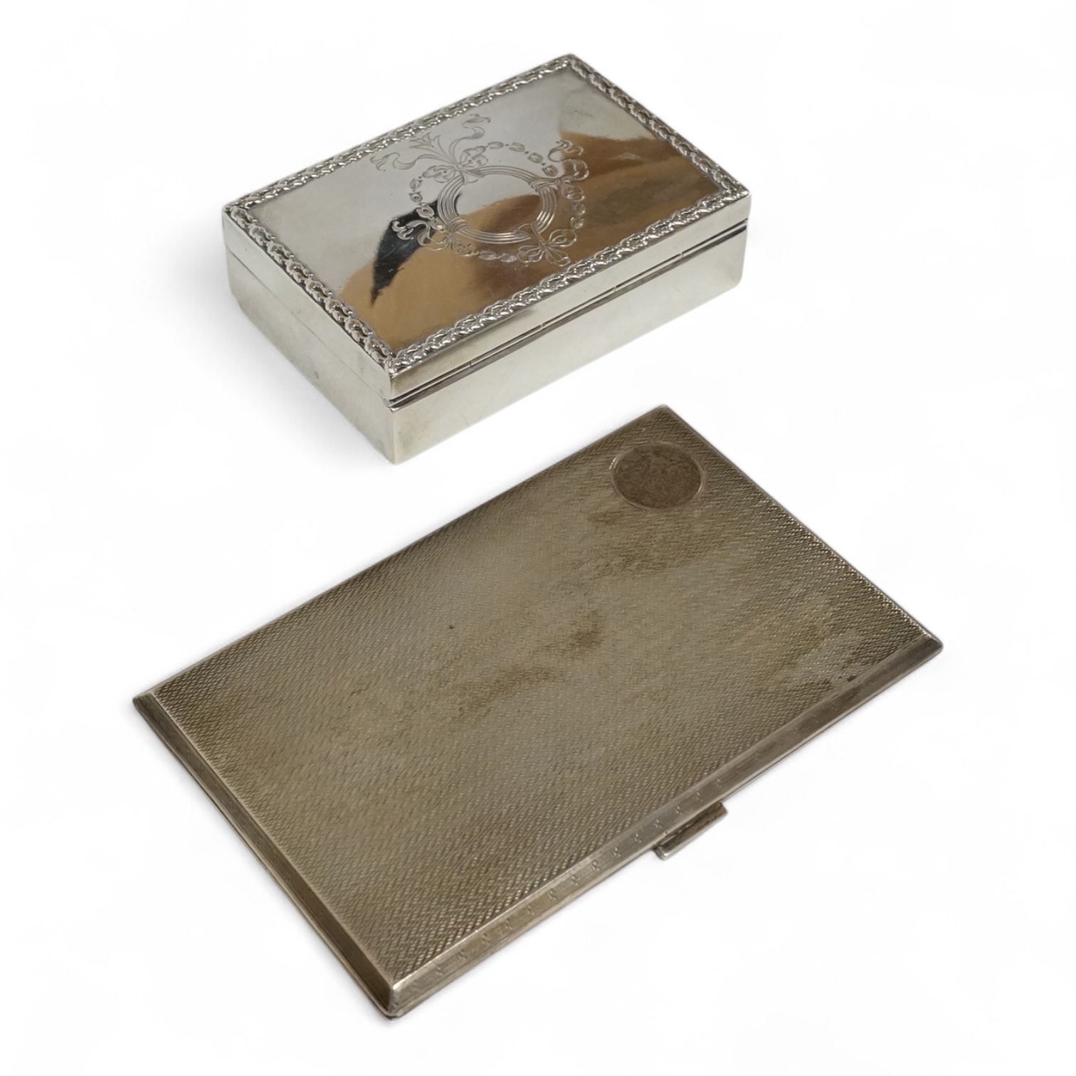A small George V silver box and cover, possibly for snuff, by Mappin & Webb, London, 1912, 95mm, together with a later engine turned silver cigarette case, 10.6oz.
